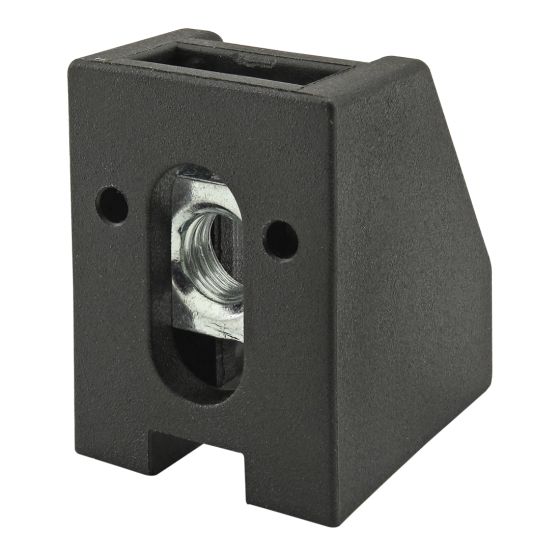 black, upright, rectangular, block with a rectangular hole at the top, and angle cut back top corner, anda oval hole on the front panel with a threaded nut inserted in the center.