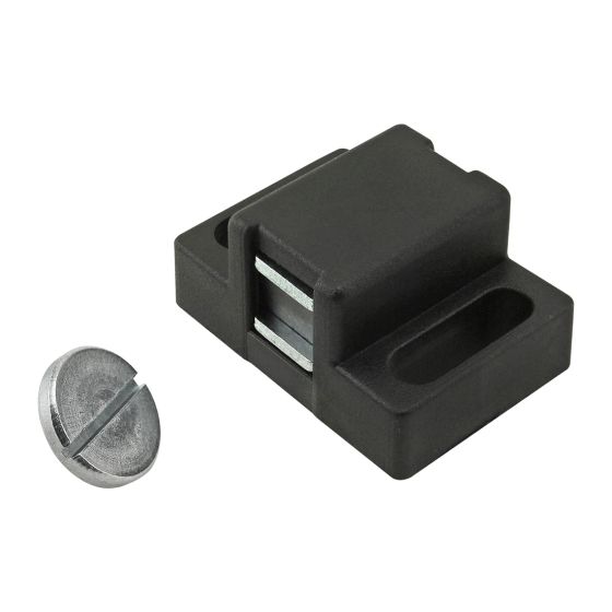 top view of a black, plastic door catch assembly that has a raised block in the center with a metal piece inserted into the left end