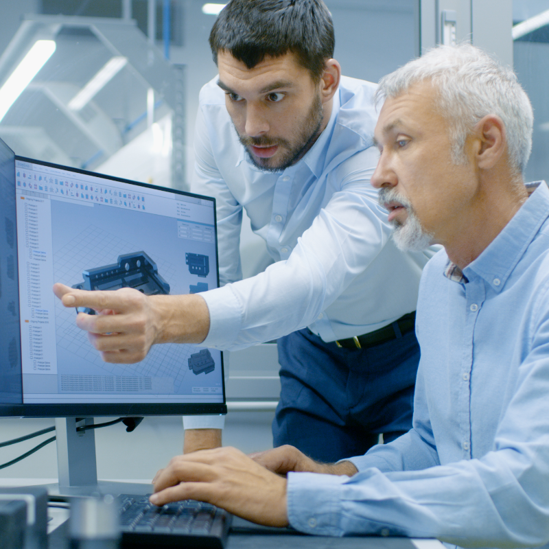 Two men looking at a cad file on a computer