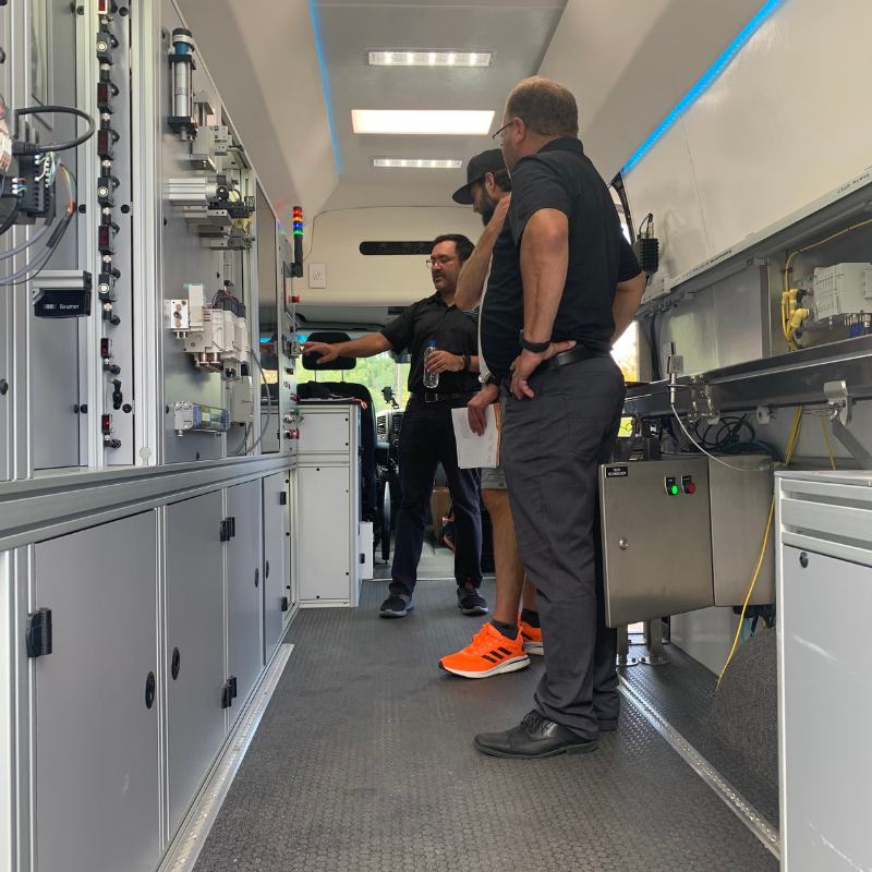 TECO Staff looking at automation and electrical panels