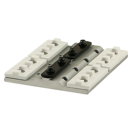 square, flat metal piece with a raised center and two black, rectangular mounting plates in the center each with two screws through them. Each side also has two white, rectangular mounting pads with two holes in each one.