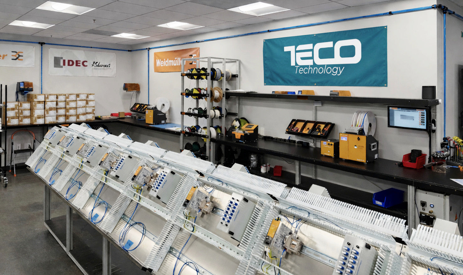 Technical workshop with TECO Technology equipment and signage