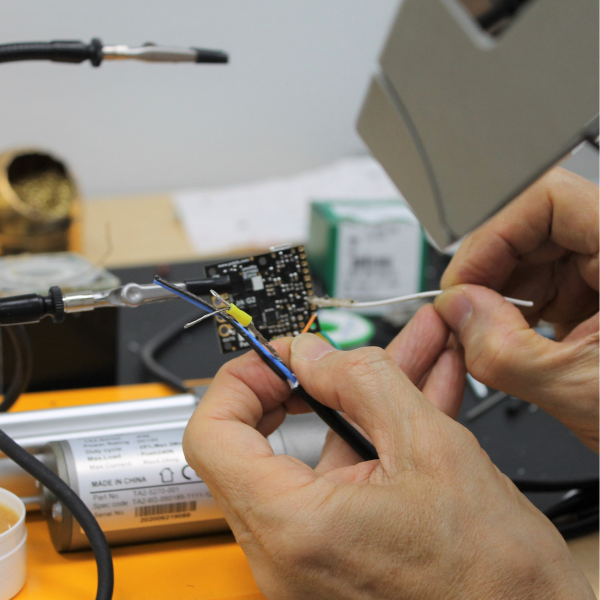 Hands performing service on a wire
