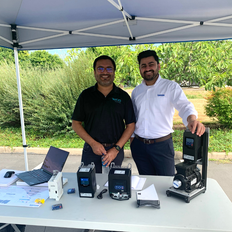 Two employees standing at automation display table