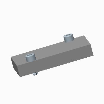 side view of a rectangular manifold with an angled front side and a screw in the top of each end