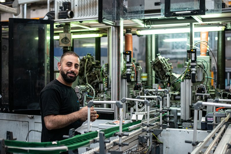 Man working next to machinery line