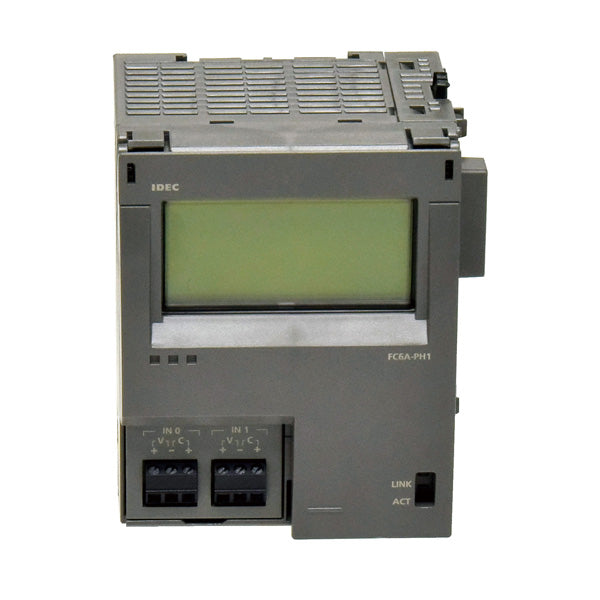 top front view of an HMI expansion module with grey housing, a black switch on the top right, a display screen in the front with input connection ports on the bottom left